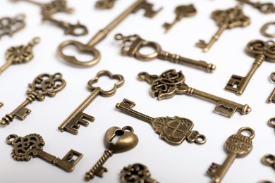 Photo of Bronze vintage ornate keys on white background
