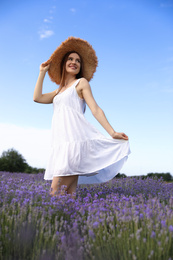 Photo of Young woman in lavender field on summer day