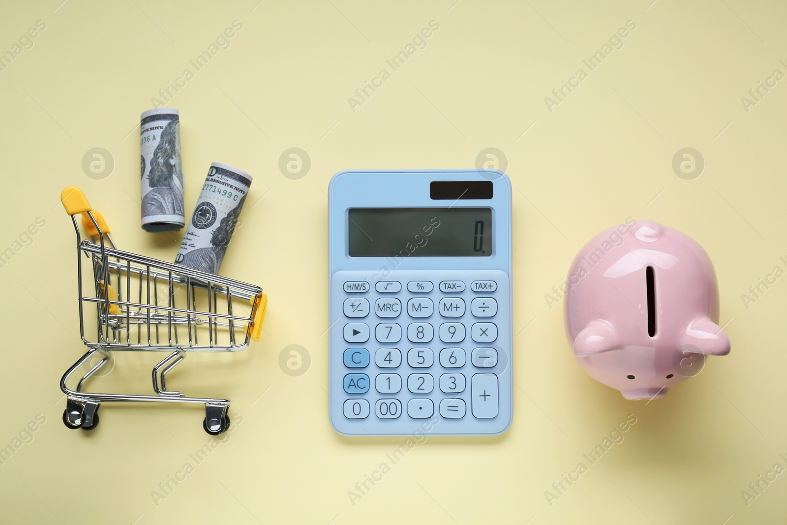 Photo of Flat lay composition with piggy bank and calculator on beige background