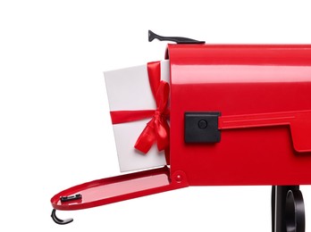 Photo of Red mailbox with Christmas gift isolated on white. Sending present by mail