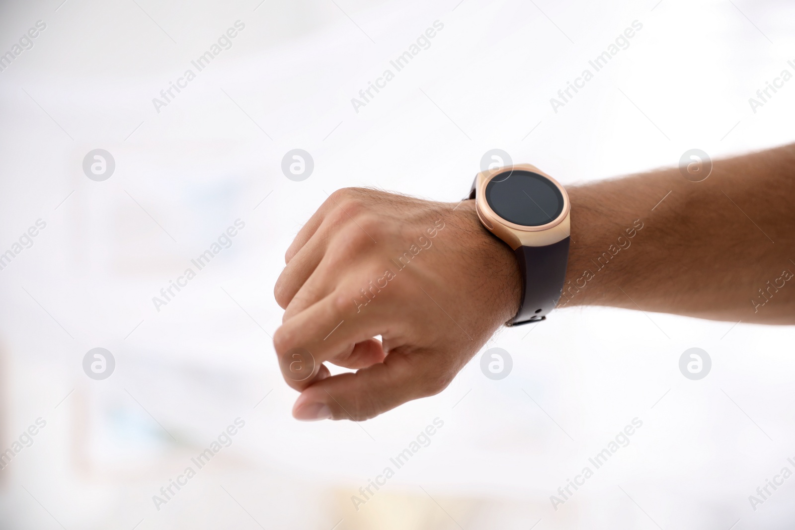 Photo of Man with smart watch on light background, closeup