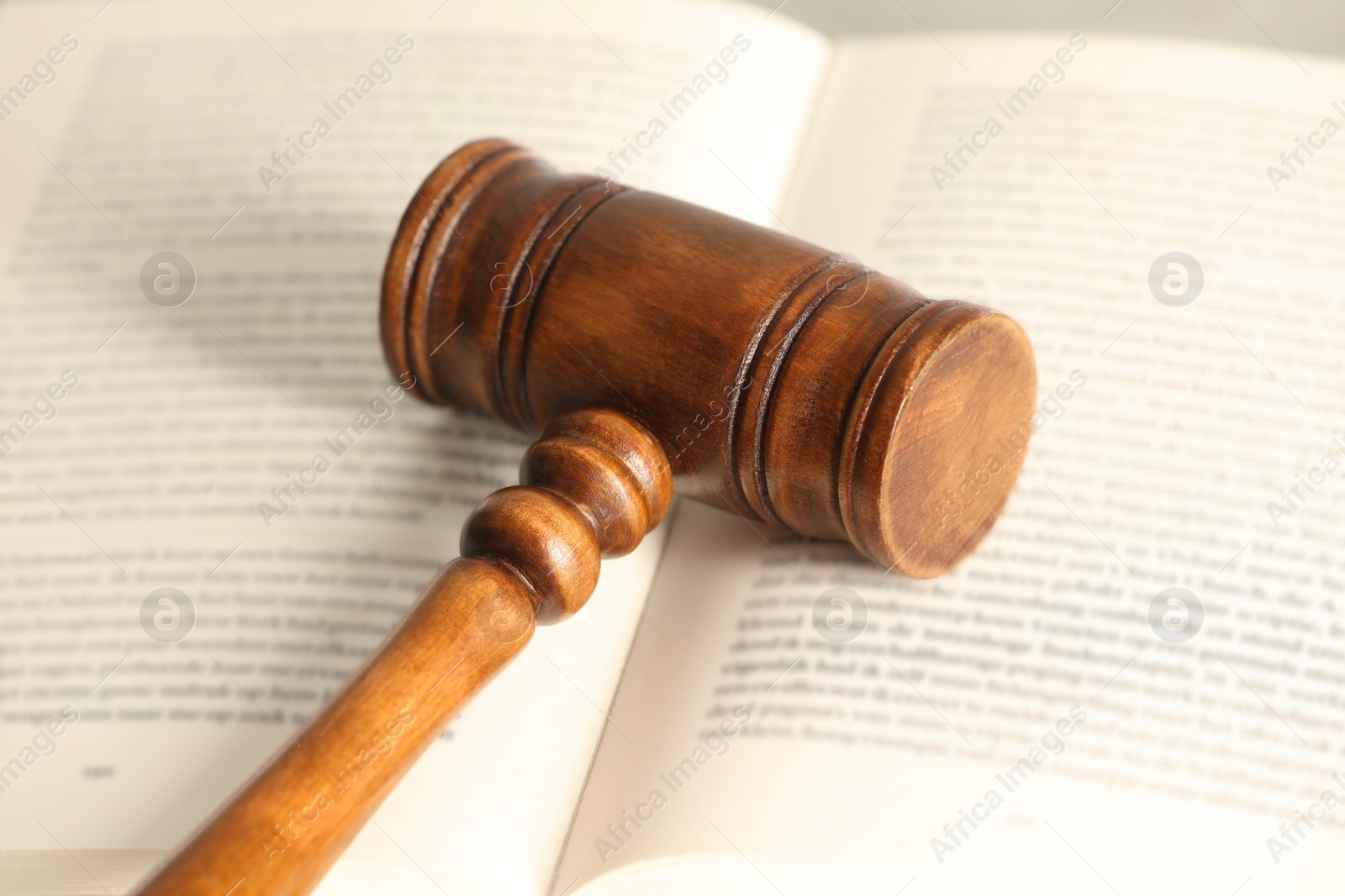 Photo of Law concept. Wooden gavel and book, closeup
