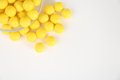 Photo of Tasty lemon drops on white background, top view