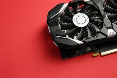 Photo of Computer graphics card on red background, above view. Space for text