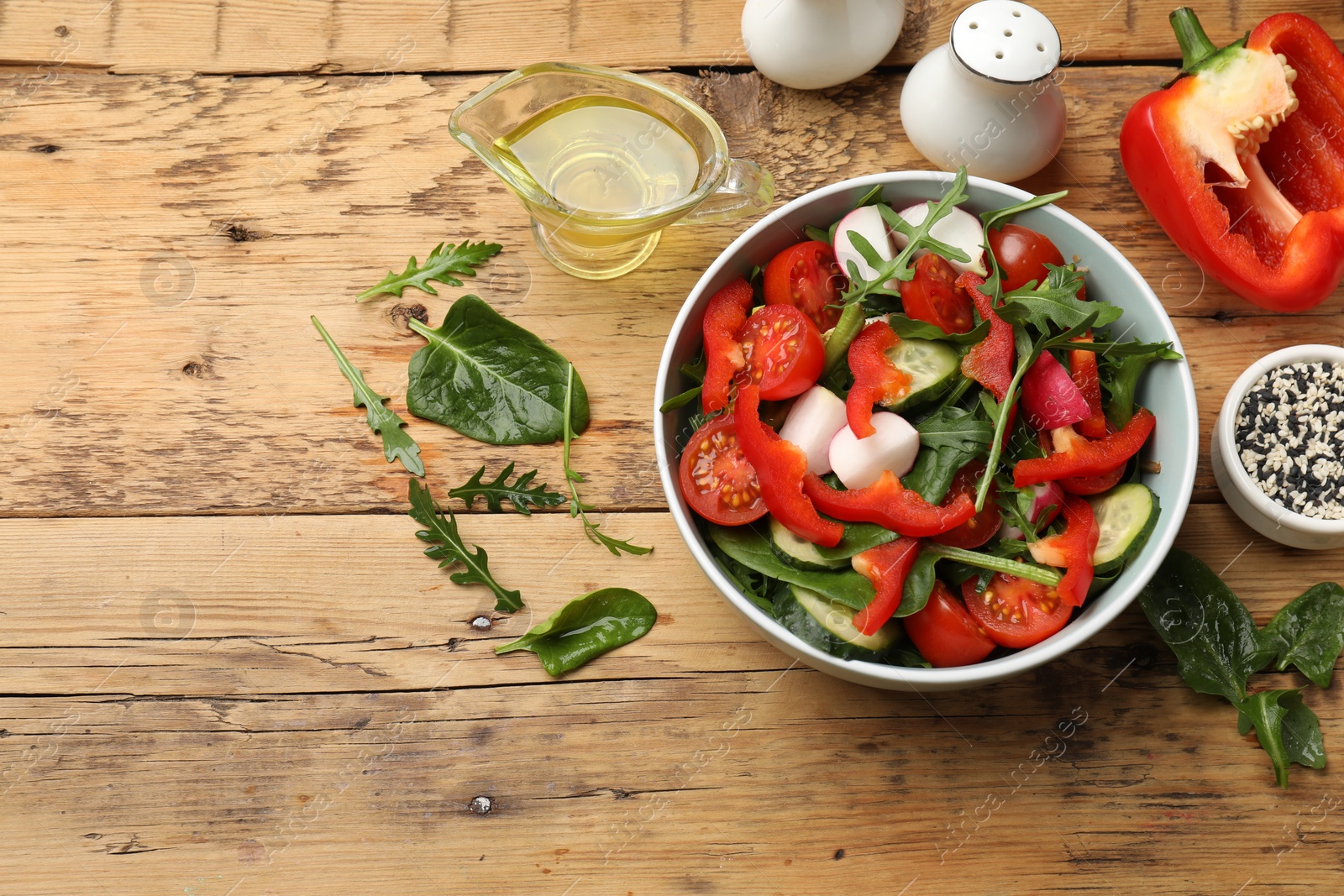 Photo of Tasty fresh vegetarian salad on wooden table, flat lay. Space for text