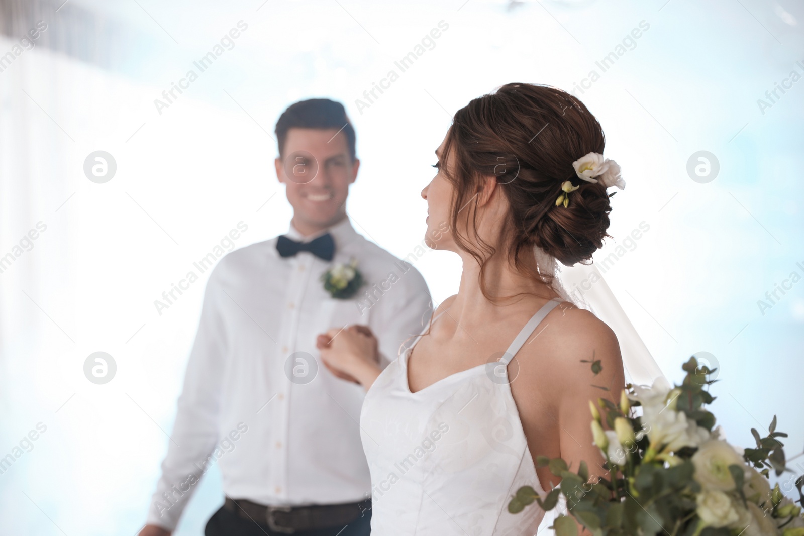 Photo of Happy newlywed couple dancing together in festive hall