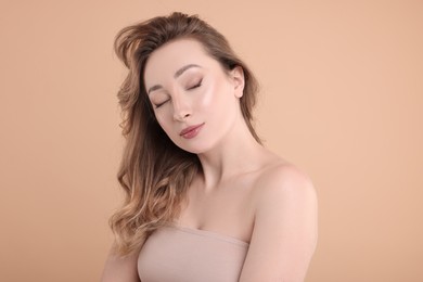 Photo of Portrait of beautiful woman on beige background