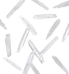 Image of Translucent menthol crystals falling on white background