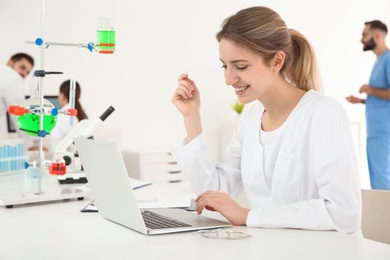 Photo of Medical student working with laptop in modern laboratory