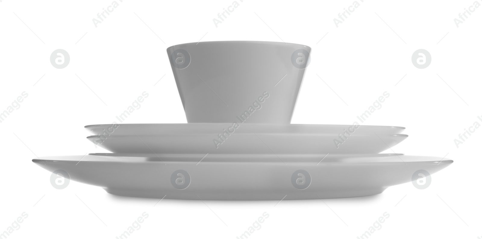 Photo of Stack of clean dishware on white background