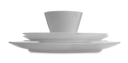 Stack of clean dishware on white background