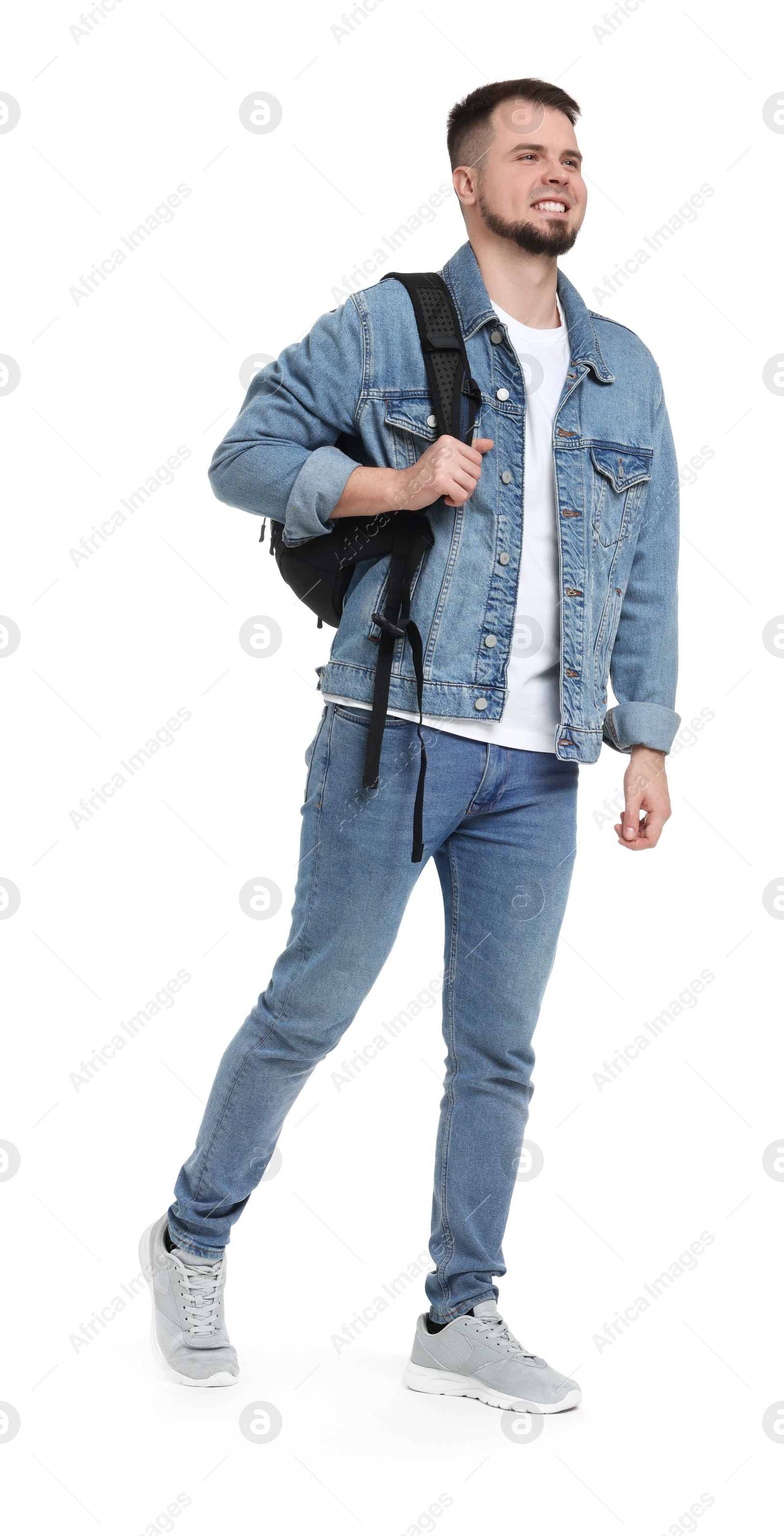 Photo of Man with backpack in denim clothes walking on white background