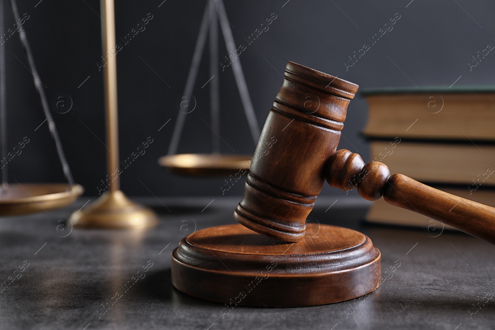 Photo of Judge's gavel and blurred scales on background. Law concept