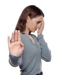 Photo of Embarrassed young woman covering face with hand on white background