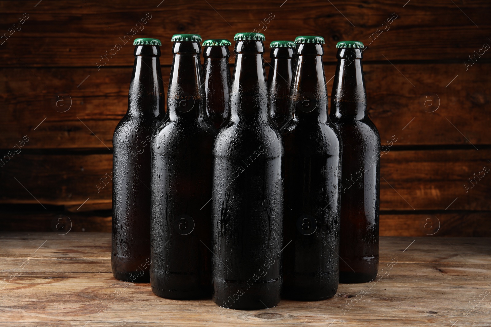 Photo of Many bottles of beer on wooden table