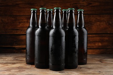 Photo of Many bottles of beer on wooden table