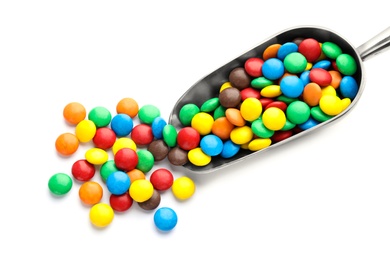 Photo of Scoop with colorful candies on white background