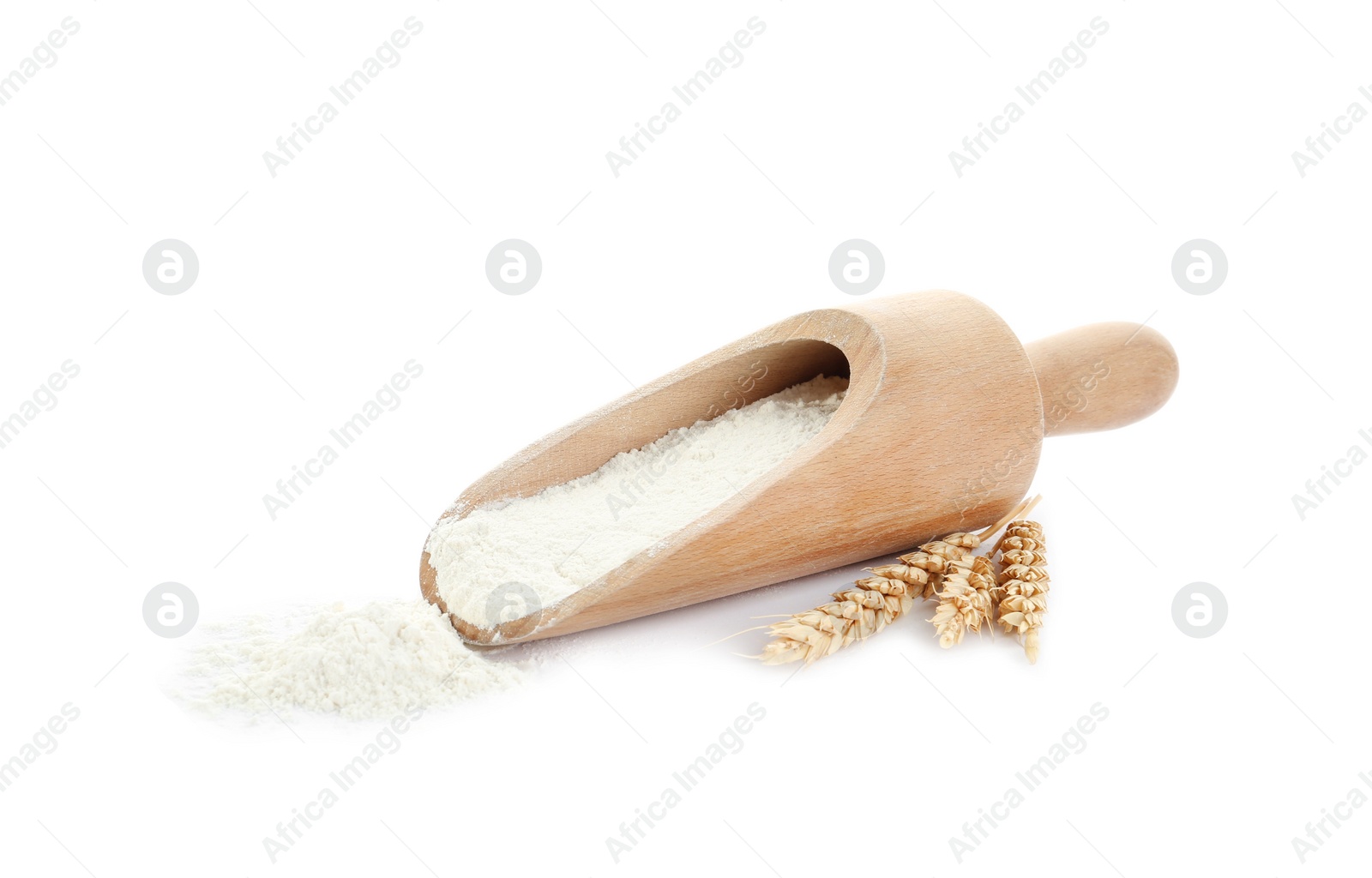 Photo of Organic flour, wooden scoop and spikelets isolated on white