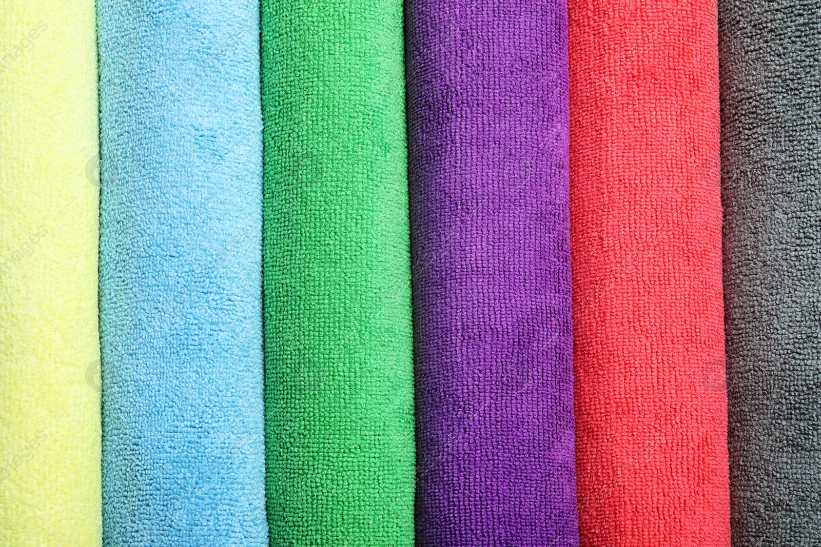 Photo of Many colorful microfiber cloths as background, top view