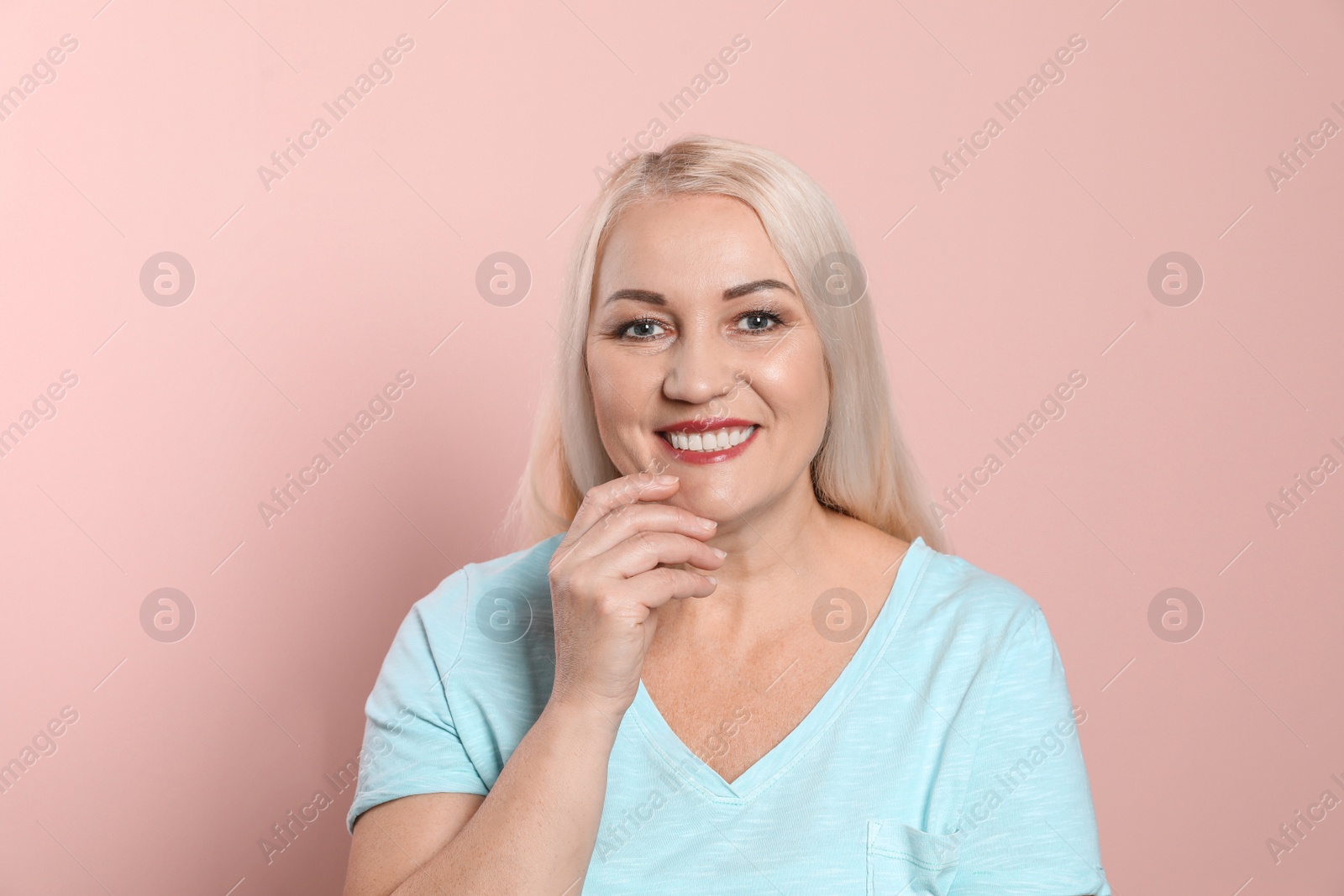 Photo of Smiling woman with perfect teeth on color background