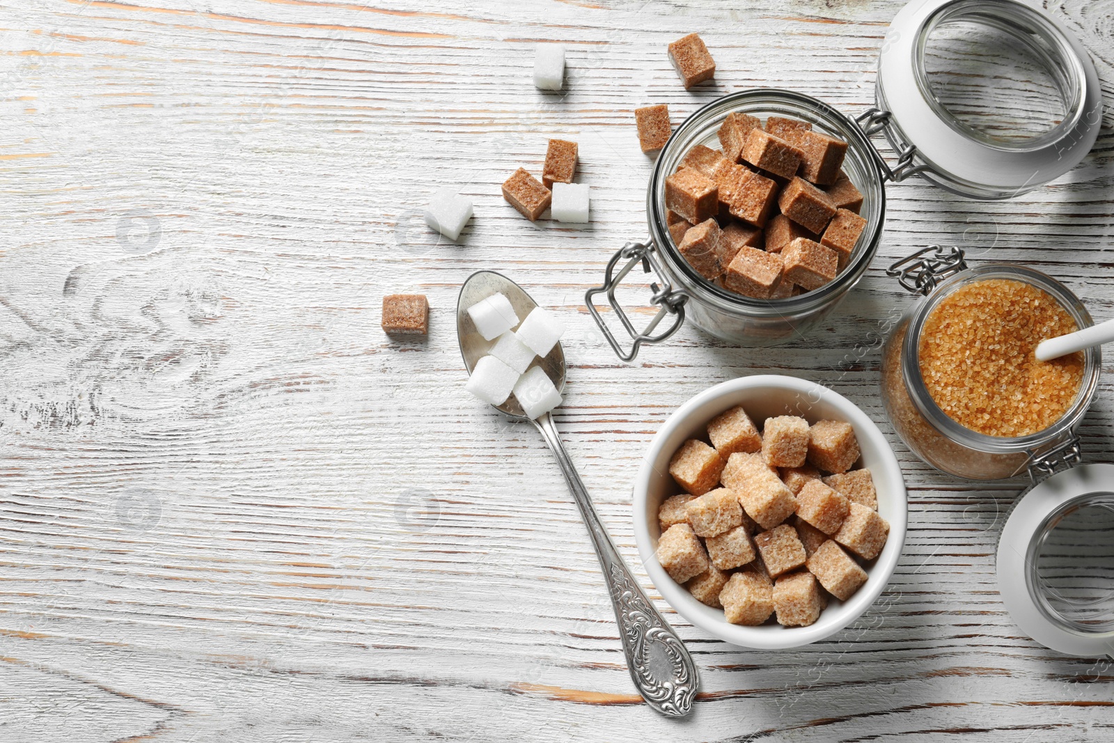 Photo of Composition with various kinds of sugar on wooden background, top view