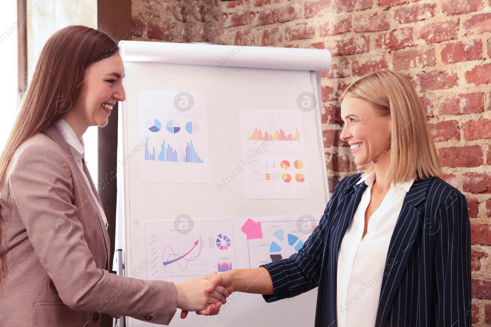 Photo of Businesswoman having meeting with her employee in office. Lady boss