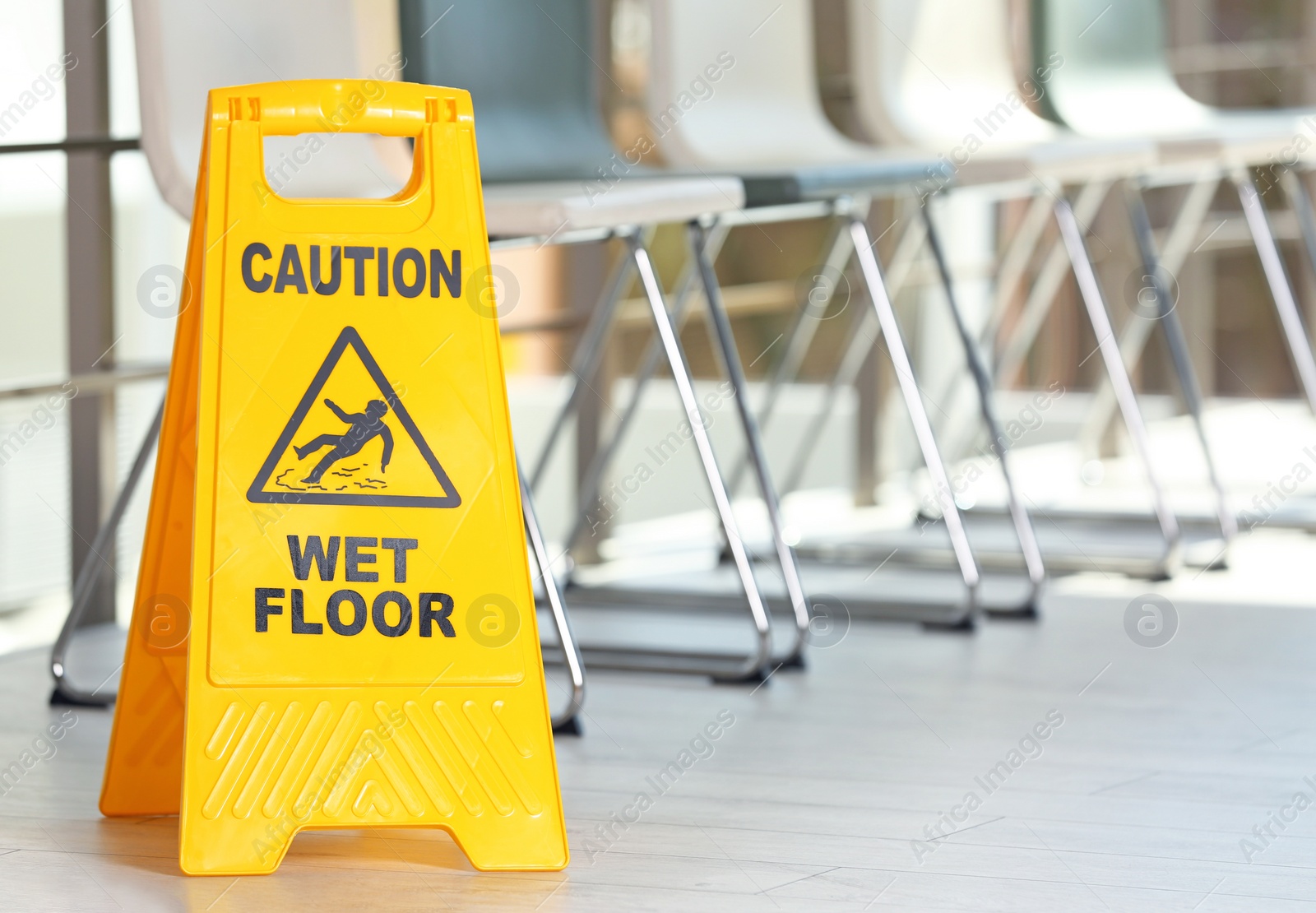 Photo of Safety sign with phrase Caution wet floor, indoors. Cleaning service