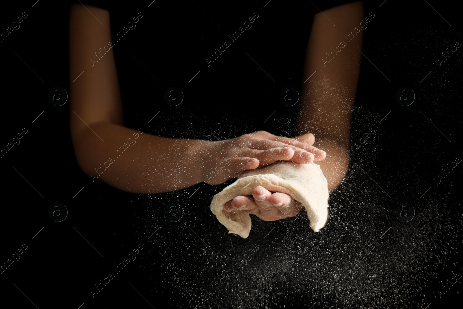 Photo of Woman preparing dough for pizza on black background, closeup
