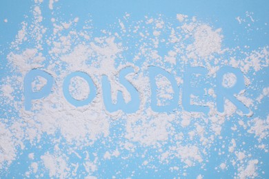 Word Powder made of baby cosmetic product on light blue background, top view