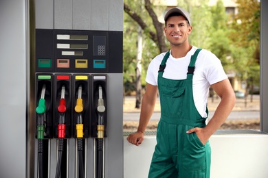 Photo of Worker in uniform at modern gas station