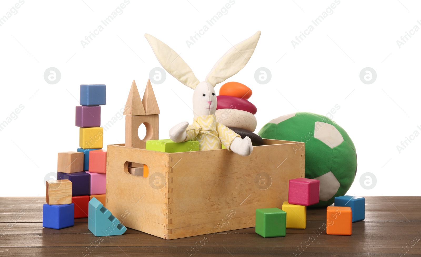 Photo of Set of different toys on wooden table against white background