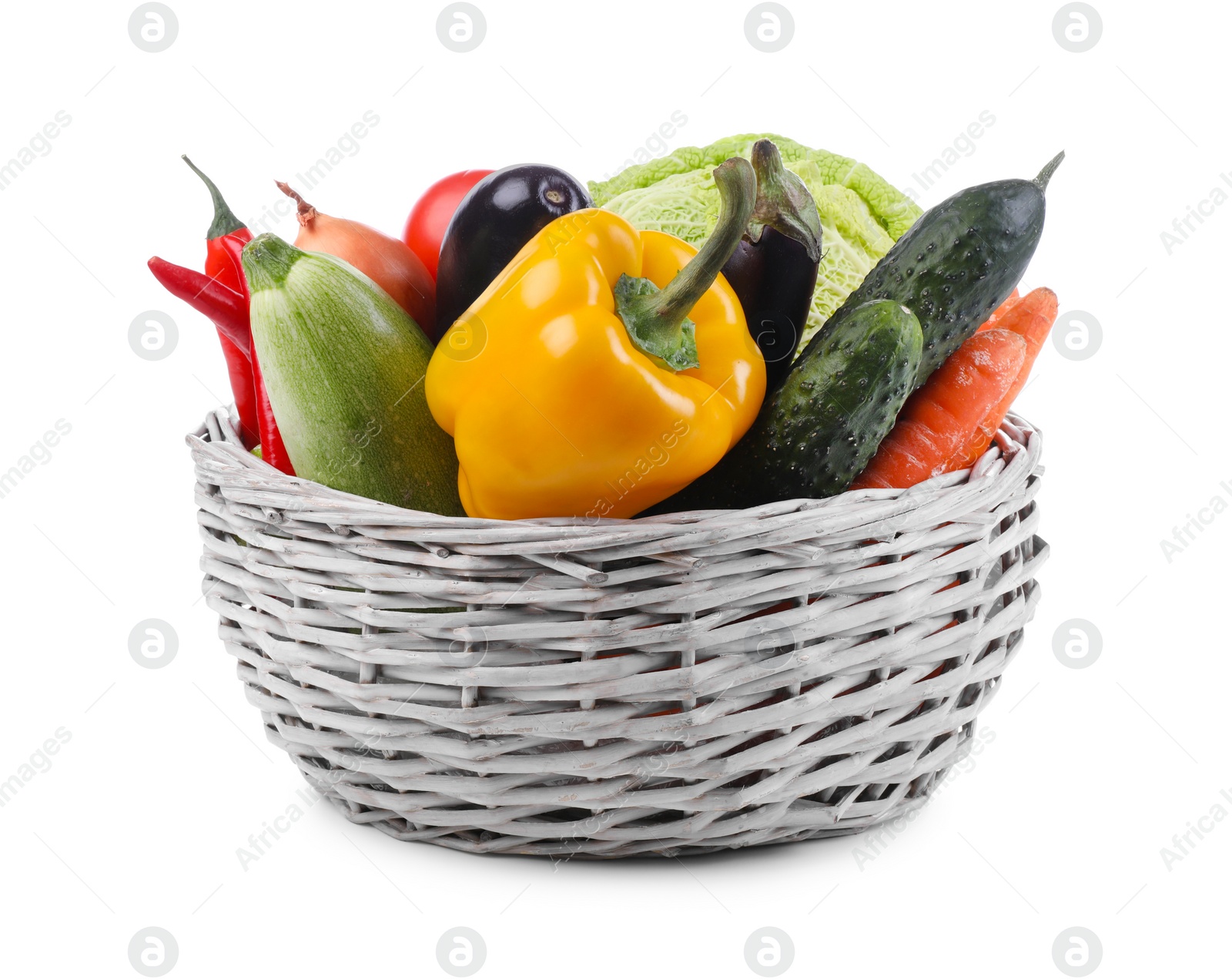 Photo of Wicker basket with fresh ripe vegetables on white background