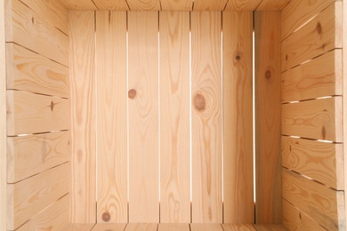 Photo of Open empty wooden crate, closeup. Inside view