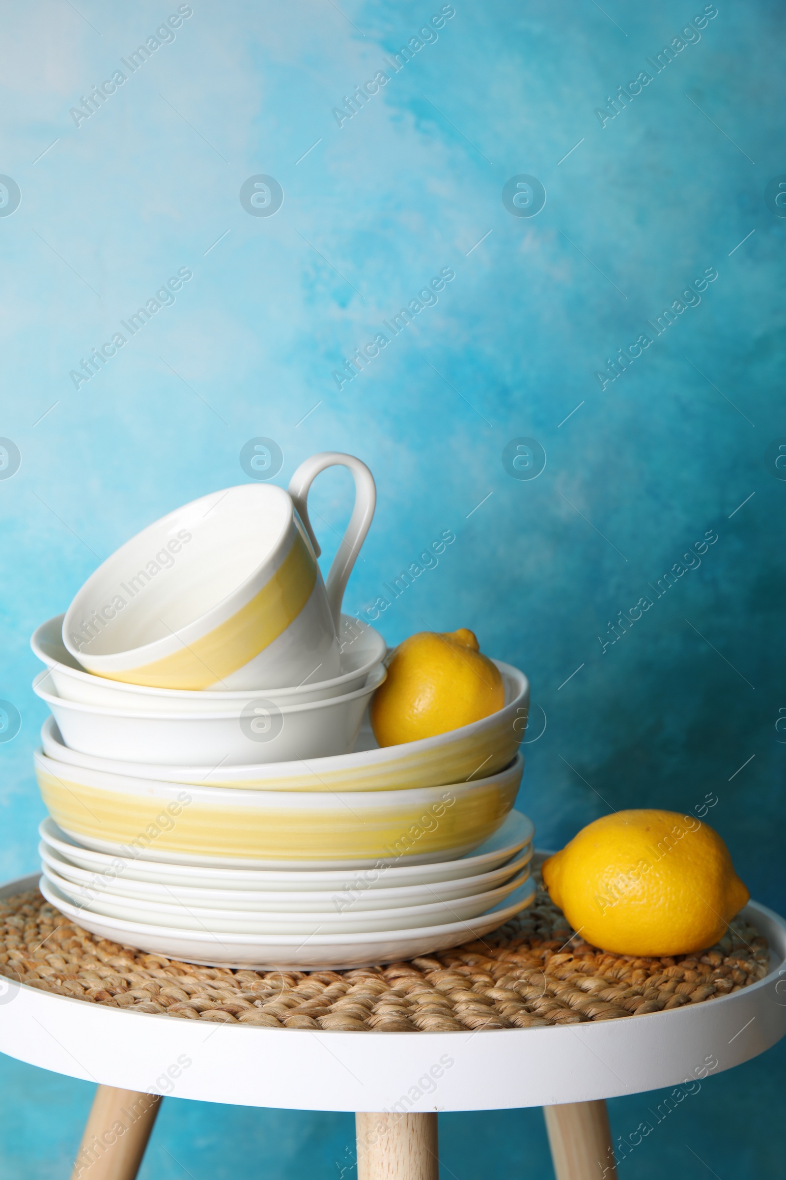 Photo of Composition with dinnerware on table against color background, space for text. Interior element