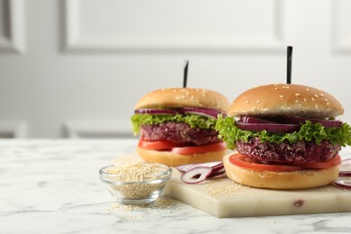 Photo of Tasty vegetarian burgers with beet patties on white marble table. Space for text
