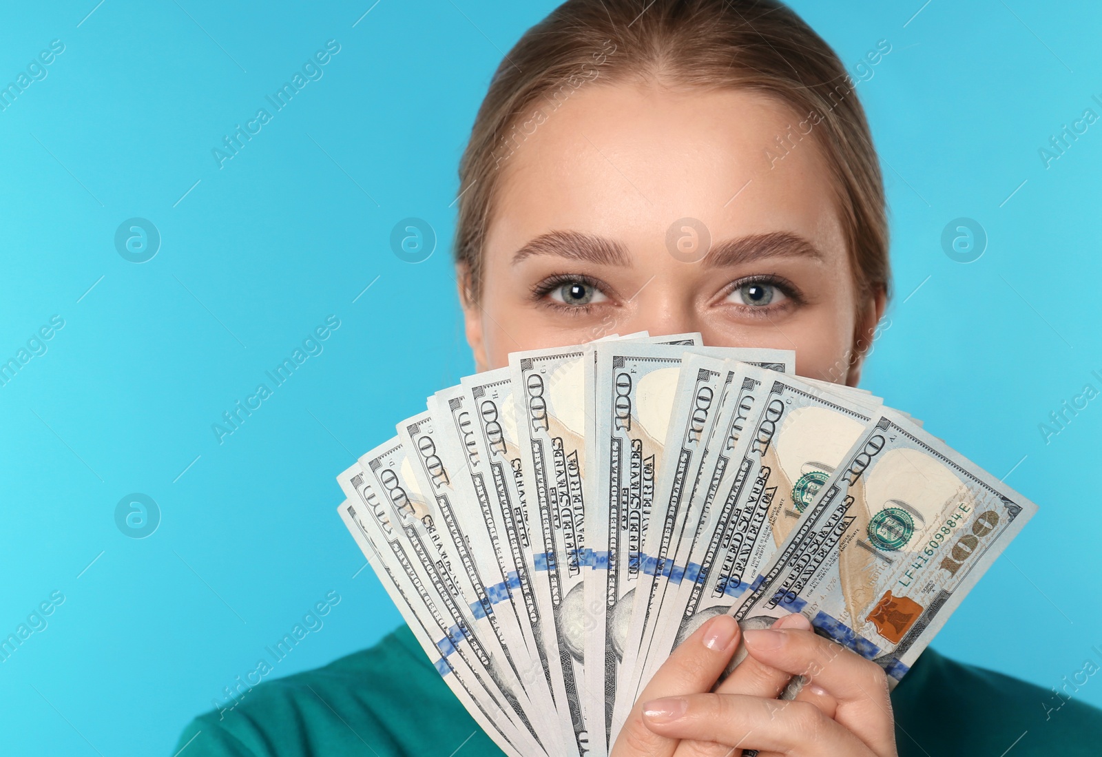 Photo of Portrait of young woman with money on color background. Space for text