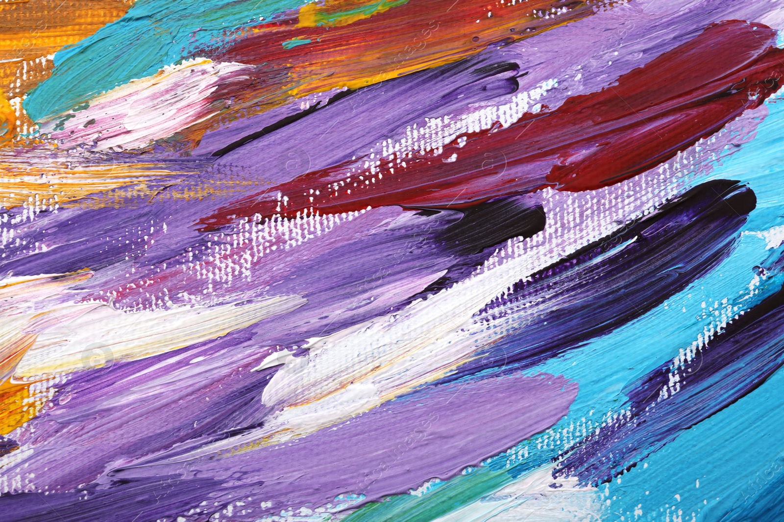 Photo of Beautiful strokes of colorful oil paints on white canvas as background, closeup