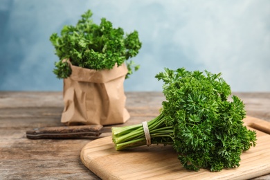 Cutting board with fresh green parsley on kitchen table