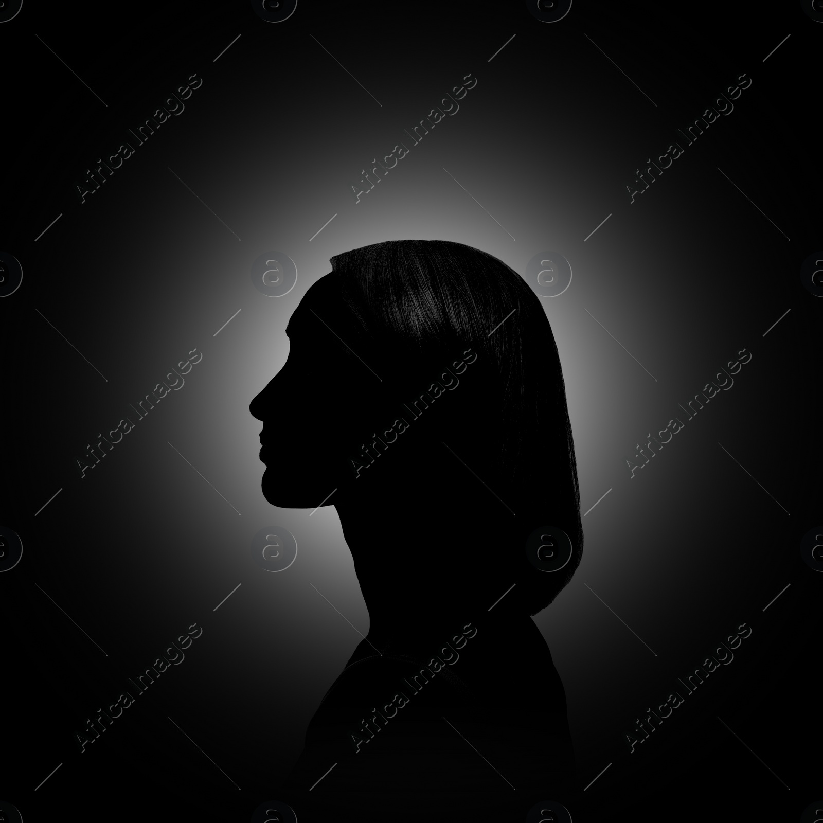 Image of Silhouette of woman in darkness. Portrait on black background