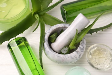 Homemade aloe gel and fresh ingredients on white wooden table, above view