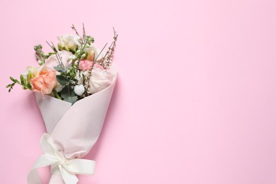 Photo of Bouquet of beautiful flowers on pink background, top view. Space for text