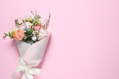 Bouquet of beautiful flowers on pink background, top view. Space for text