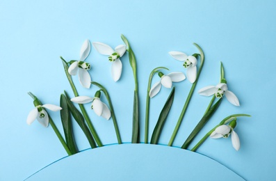 Photo of Beautiful snowdrops on turquoise background, flat lay
