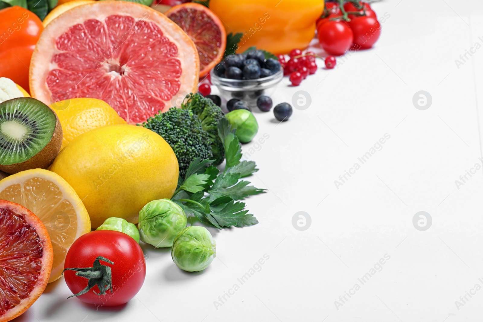 Photo of Different products rich in vitamin C on white background