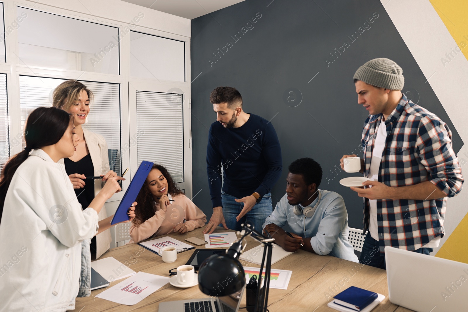 Photo of Team of employees working together in office. Startup project