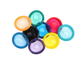 Unpacked colorful condoms on white background, top view. Safe sex