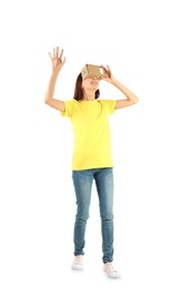 Photo of Young woman using cardboard virtual reality headset, isolated on white