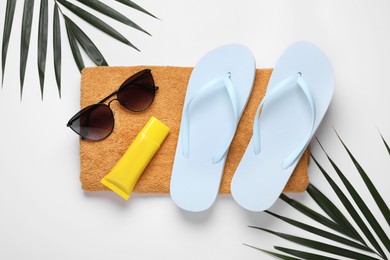 Photo of Flat lay composition with sunscreen and beach accessories on white background