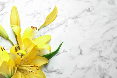 Photo of Flat lay composition with beautiful blooming lily flowers on marble background