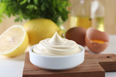 Photo of Fresh mayonnaise sauce in bowl on white table, closeup